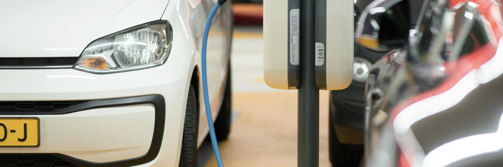 Electric cars charging in a brightly lit parking garage