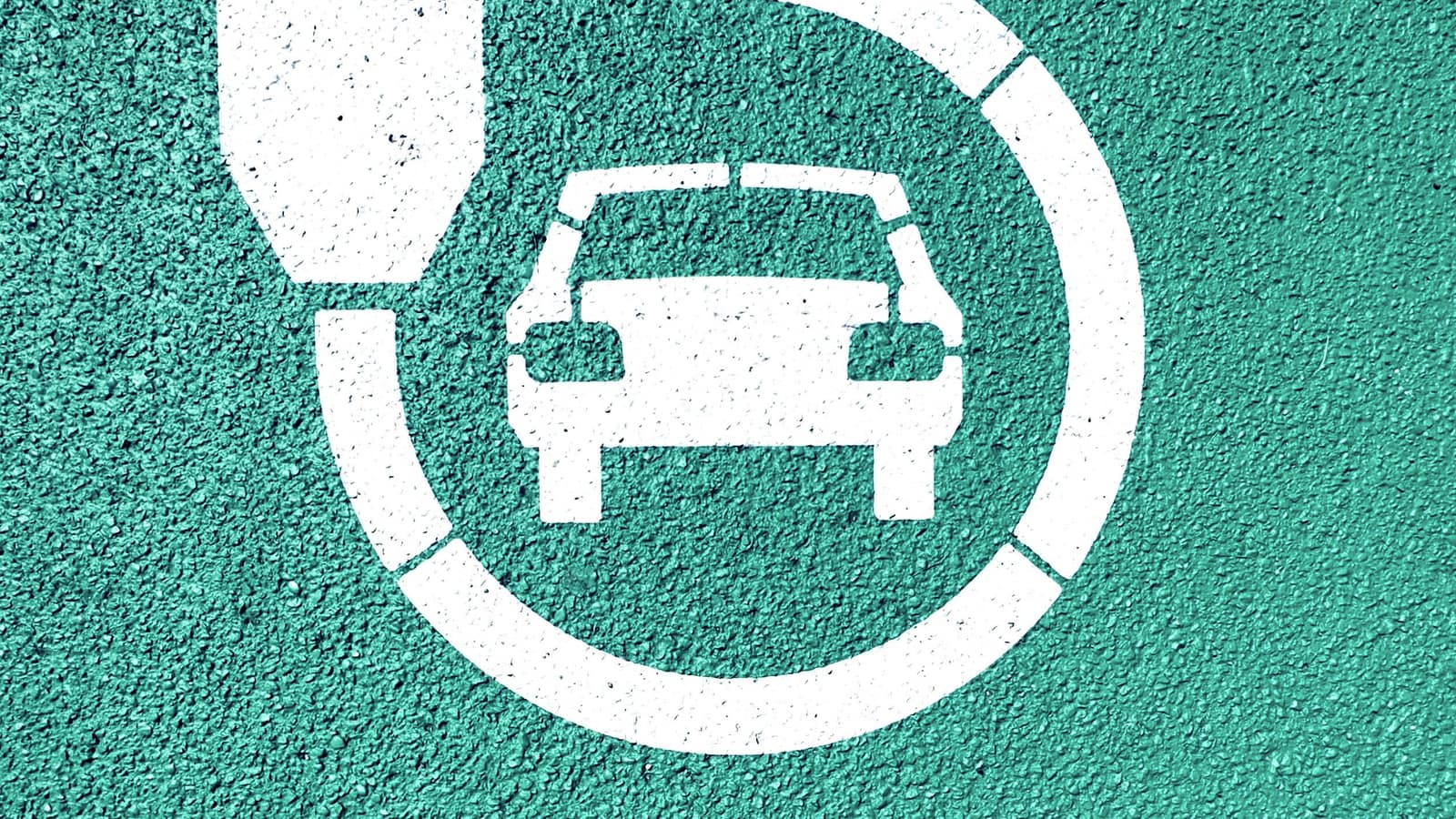 A painted road marking of an electric car circled by a charging-plug symbol