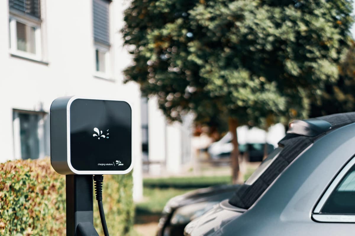 A technician connecting an electric car to a wallbox charger